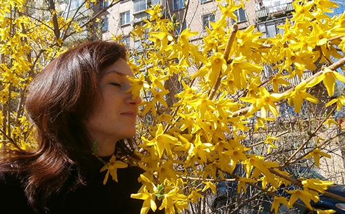 Olga inhales the aromas of yellow flowers