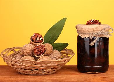 Walnuts in a basket and jam in a jar