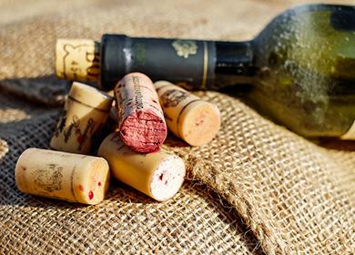 Antique bottle and a bunch of corks lie on a burlap