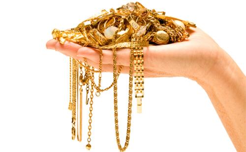 Gold jewelry in hand