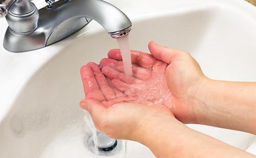 Hands wet under tap