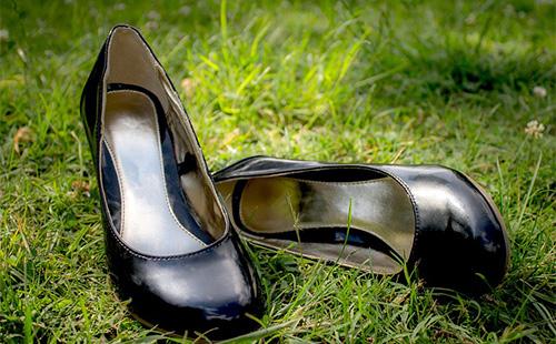 Leather black shoes on the grass