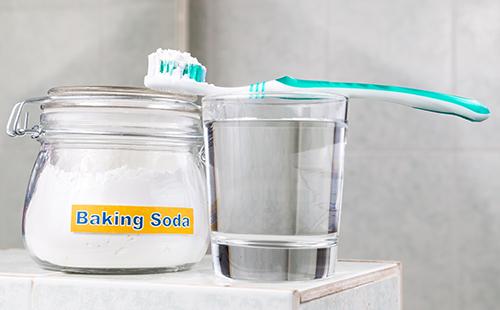 Baking soda in a jar and a toothbrush
