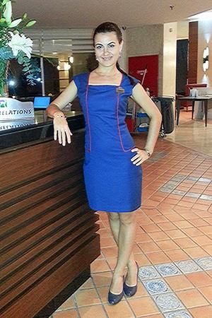 Hope in a blue dress stands at the counter