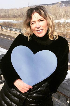 Veronica holds a huge blue heart