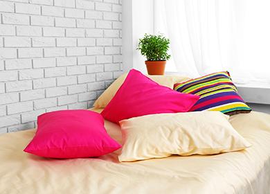 Multi-colored pillows on the bed