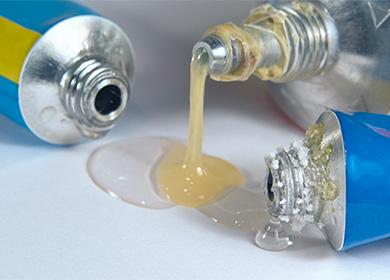 Liquid glue flows from a tube