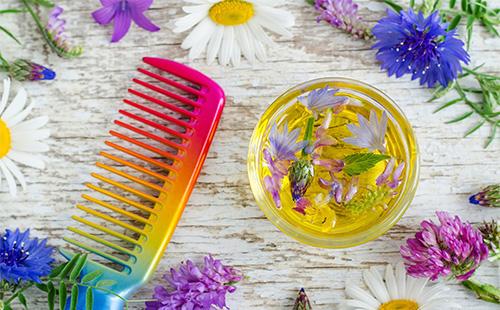 Olive oil in a bowl and a multi-colored comb
