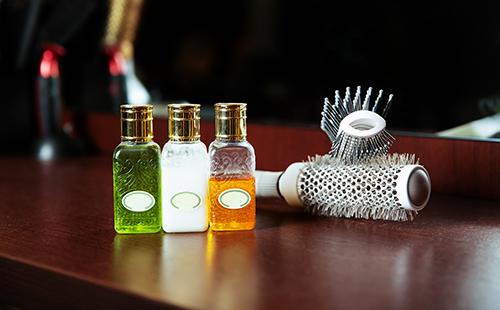 Three vials of oils and hair brushes