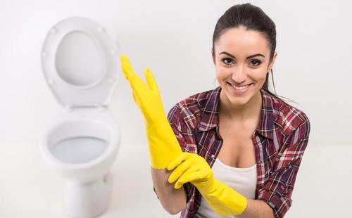 Woman puts on rubber gloves