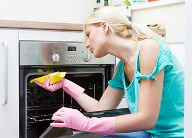 Woman washes an oven