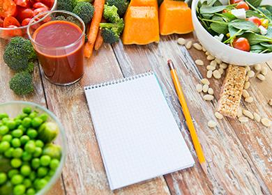 Sliced ​​vegetables and notebook for scoring