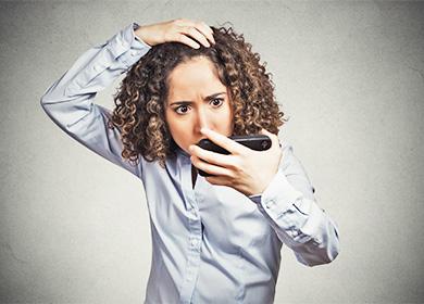 Woman looking at hair falling out