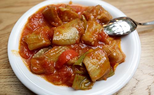 Vegetable stew in a plate with a spoon