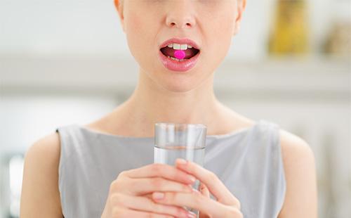 Woman drinking a pill