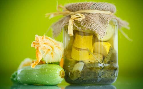 canned zucchini in a jar with a lid of fabric