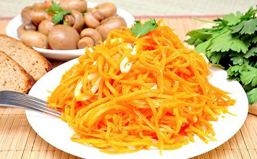 Grated carrots and mushrooms in the background