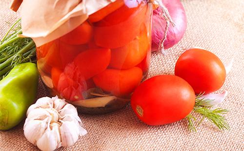 Canned tomatoes in a jar of green pepper