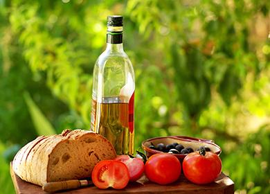 Pan casero, tomates y una botella de aceite de oliva.