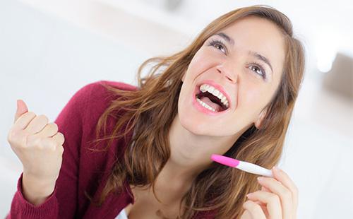 Girl rejoices at the result of a pregnancy test