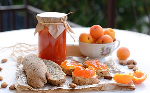 Jar with apricot jam on the table