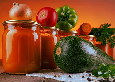 Jars with adjika, zucchini, tomatoes and bell pepper