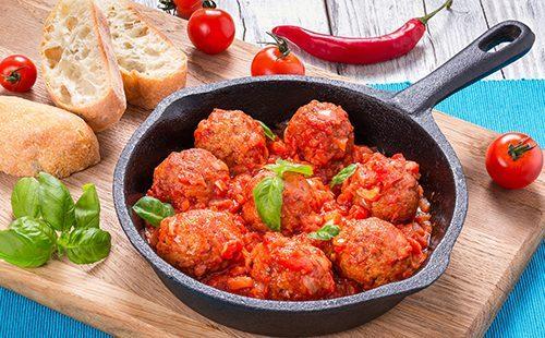 Meatballs with basil leaves