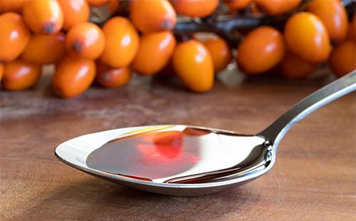 Sea buckthorn oil in a spoon