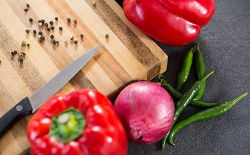 Sweet peppers, onion and knife