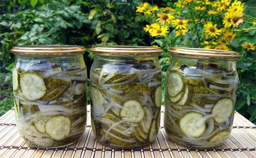 Three cans with cucumber salad for the winter