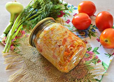 Jar with salad lies among vegetables