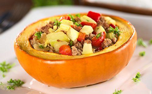 Half pumpkin with meat and zucchini