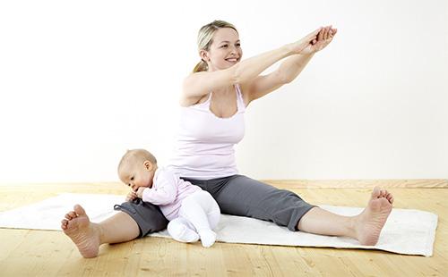 Woman doing exercises at home with baby