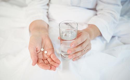 White pills in hand