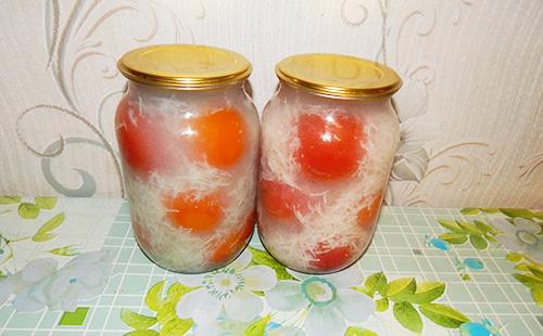 Pickled tomatoes with garlic in jars