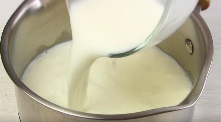 Pour milk into the stewpan to prepare the cream.