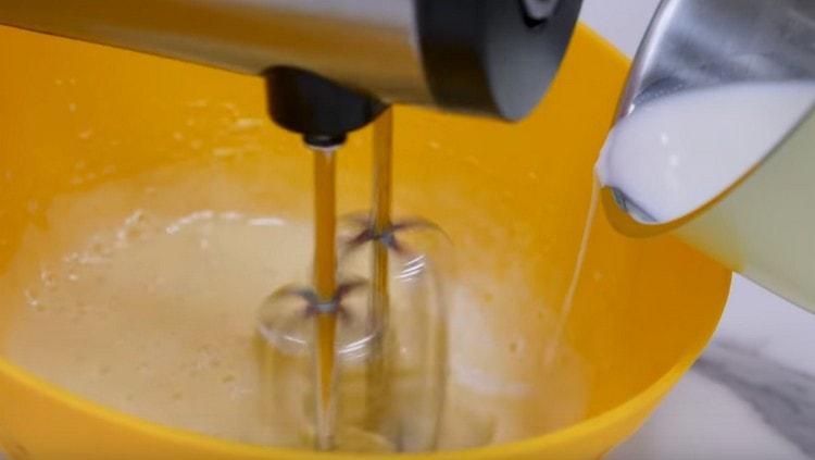 Pour hot milk into a frying egg in a thin stream.