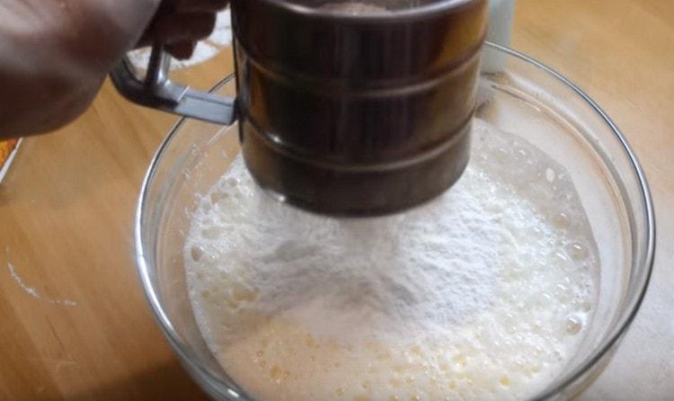 Sift flour into the dough, mix.