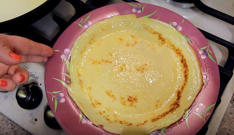 After frying, each pancake needs to be greased with melted butter.