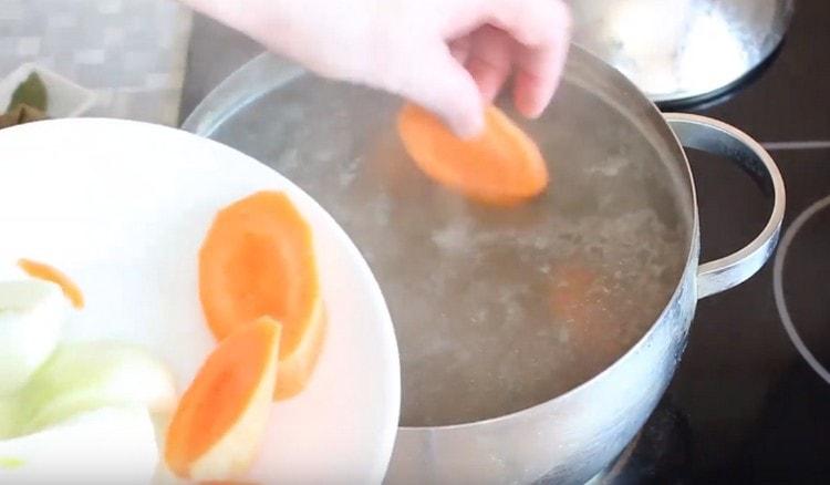 Cortar las zanahorias en trozos grandes y agregar a la sartén a la carne.
