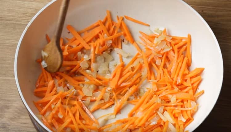 Add carrot to the onion, simmer.