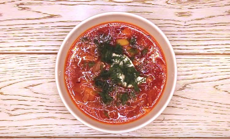 Vegetarian borsch can be served with sour cream and fresh herbs.