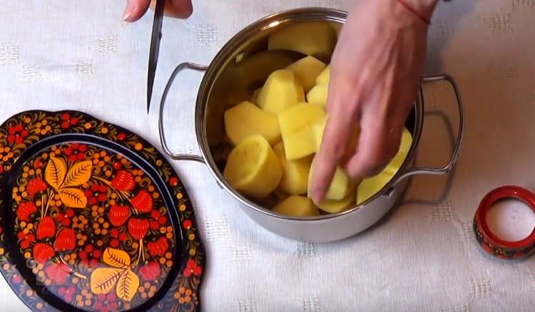 Épluchez et coupez les pommes de terre en gros morceaux.