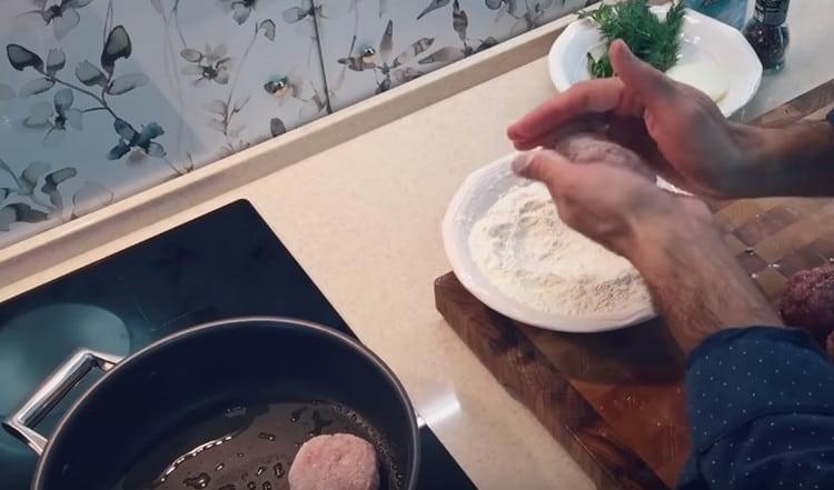 Chuletas empanizadas en harina y untadas en una sartén caliente con aceite vegetal.