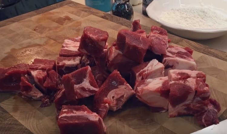 Cut large pieces of frozen beef.