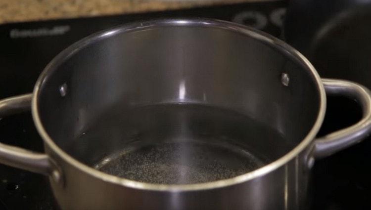 We put a pot of water on the stove and bring to a boil.