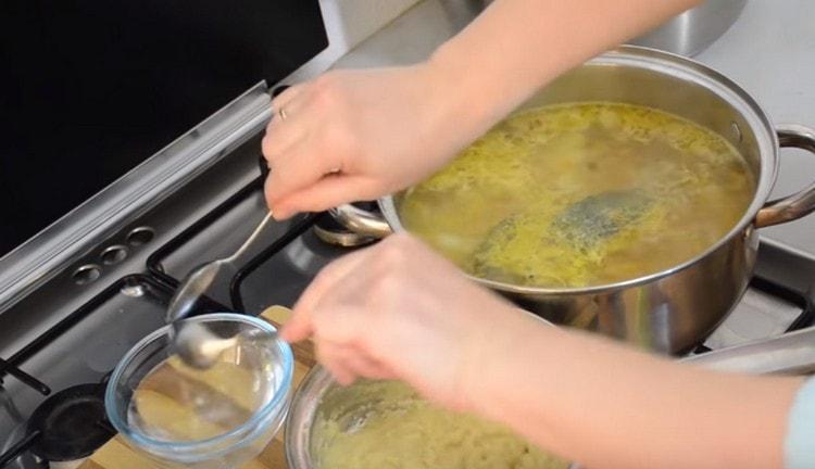 two teaspoons are wetted in cold water.