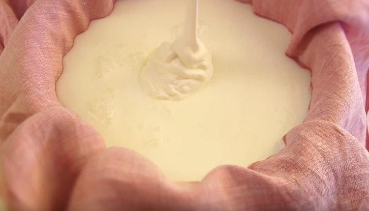 Da biste pripremili krem ​​sir, sipajte kiselo vrhnje i kefir u fil za tijesto prekriven prirodnom krpom.