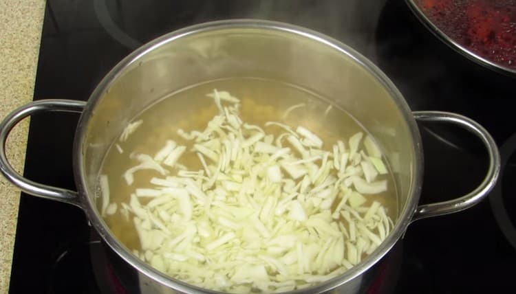 We put cabbage in a pot with almost ready beans.