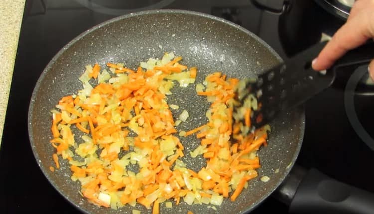 Add carrot to the onion in the pan.